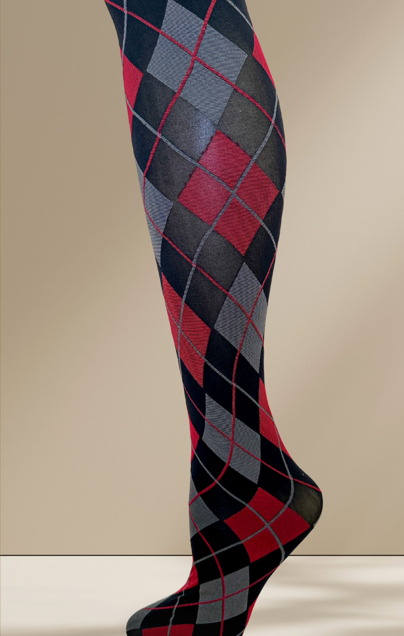 Argyle patterned knee-high socks on a beige background