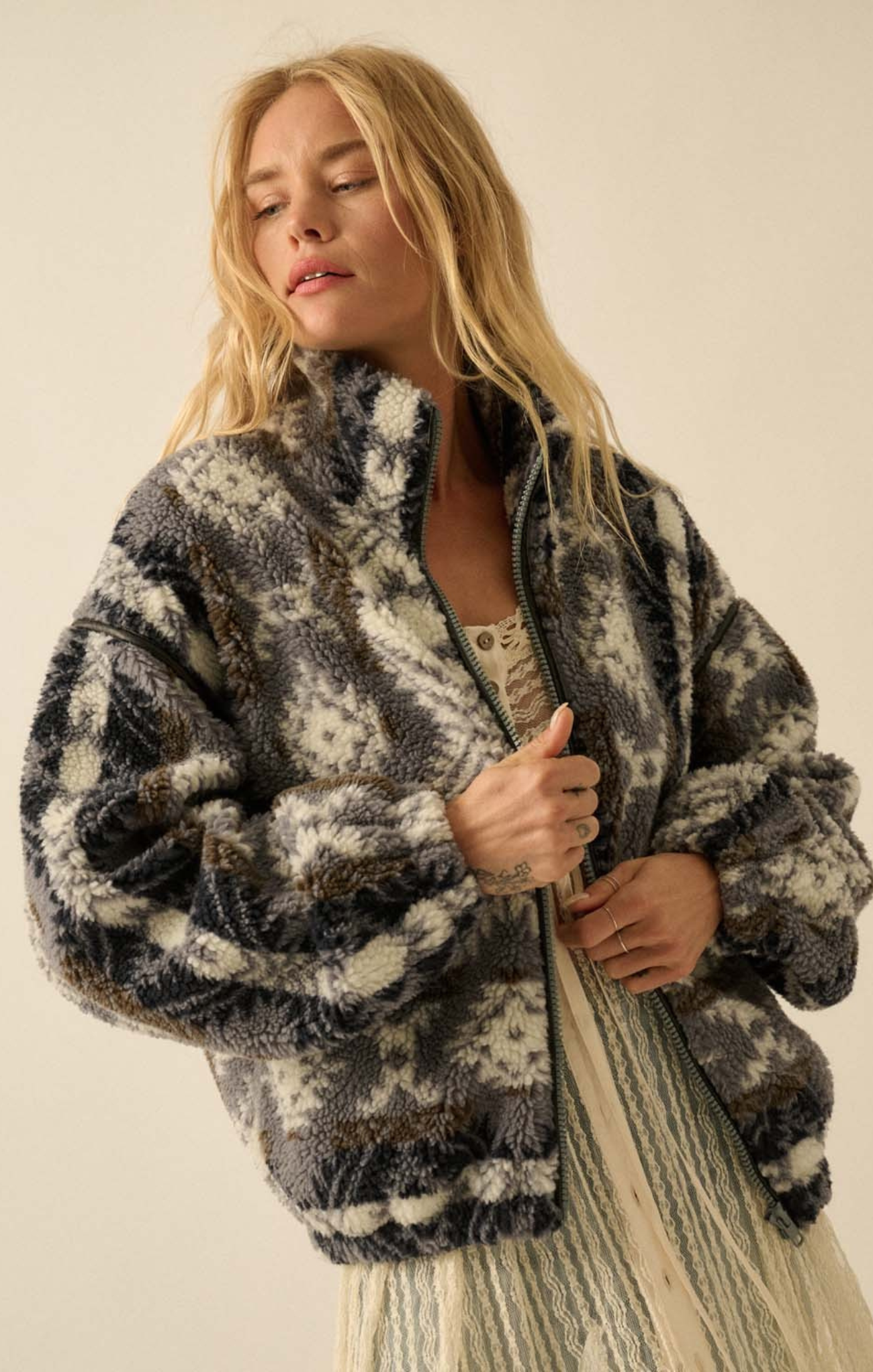 Woman wearing a patterned jacket against a plain background