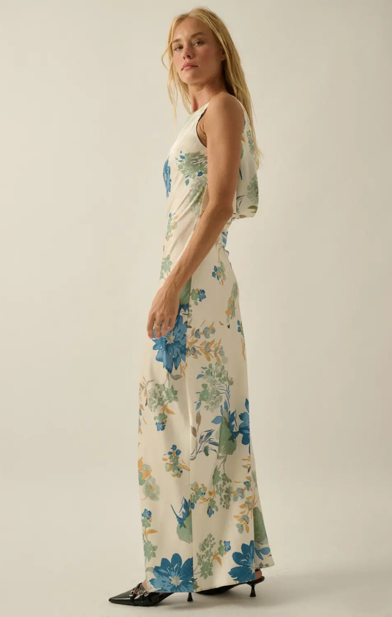 Woman wearing a floral dress on a plain background