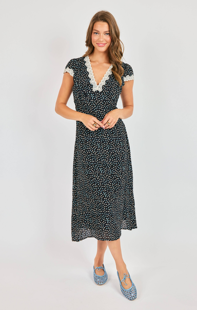Woman wearing a black and white patterned dress on a white background