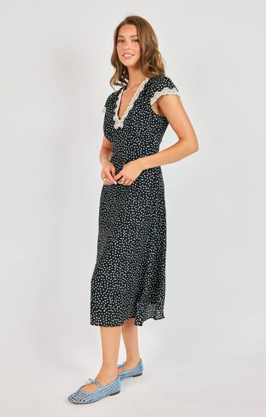 Woman wearing a black and white patterned dress on a white background