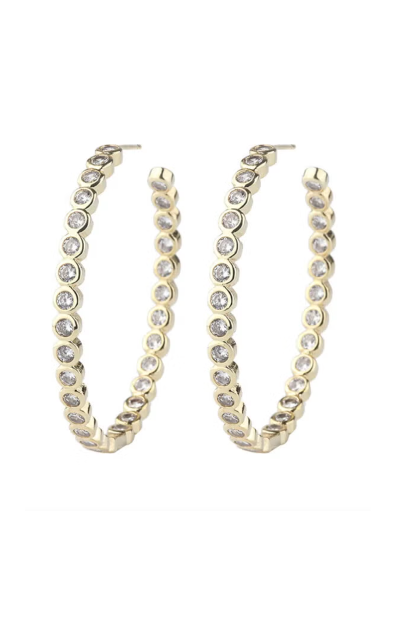 Gold hoop earrings with clear gemstones on a white background