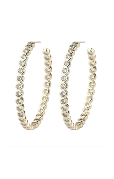 Gold hoop earrings with clear gemstones on a white background