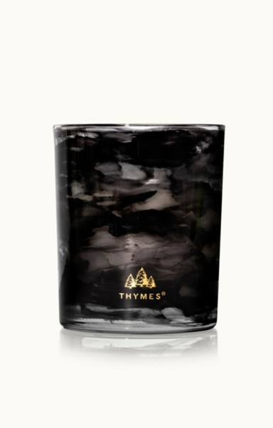 Black marbled candle with 'Thymes' logo on a white background