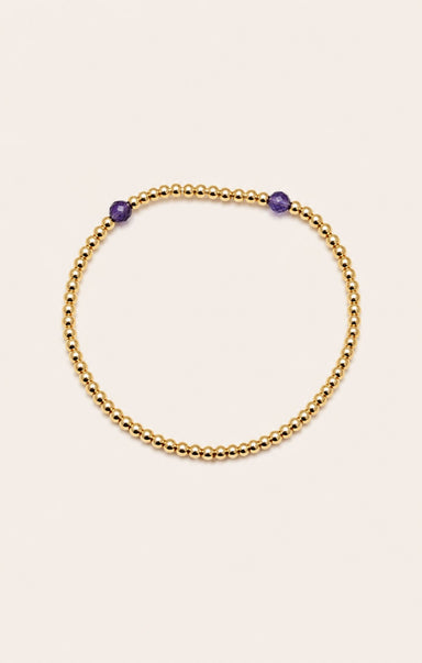 gold bracelet on neutral background