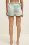 Person wearing green and white striped shorts on a plain background