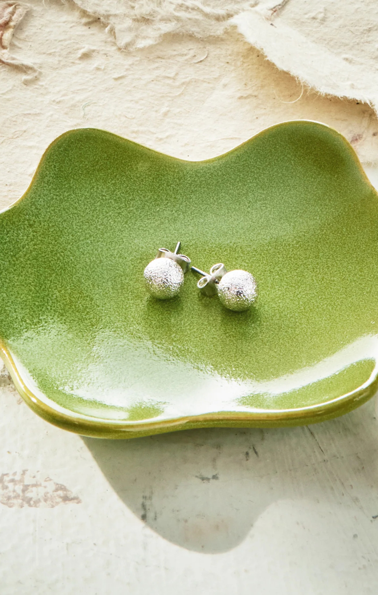 Green ceramic dish on a white background