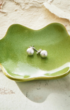 Green ceramic dish on a white background