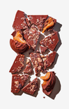 Broken pieces of chocolate with nuts on a white background