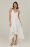 Woman wearing a white lace dress on a plain background