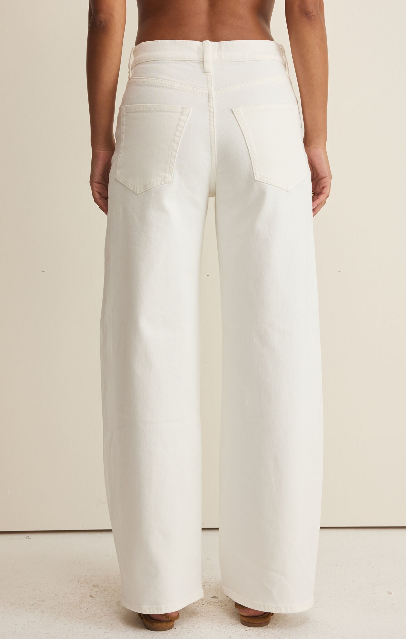 White wide-leg pants worn by a person on a plain background