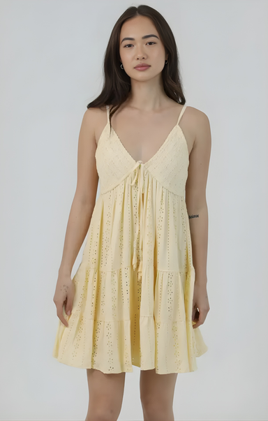 Woman wearing a yellow dress against a white background