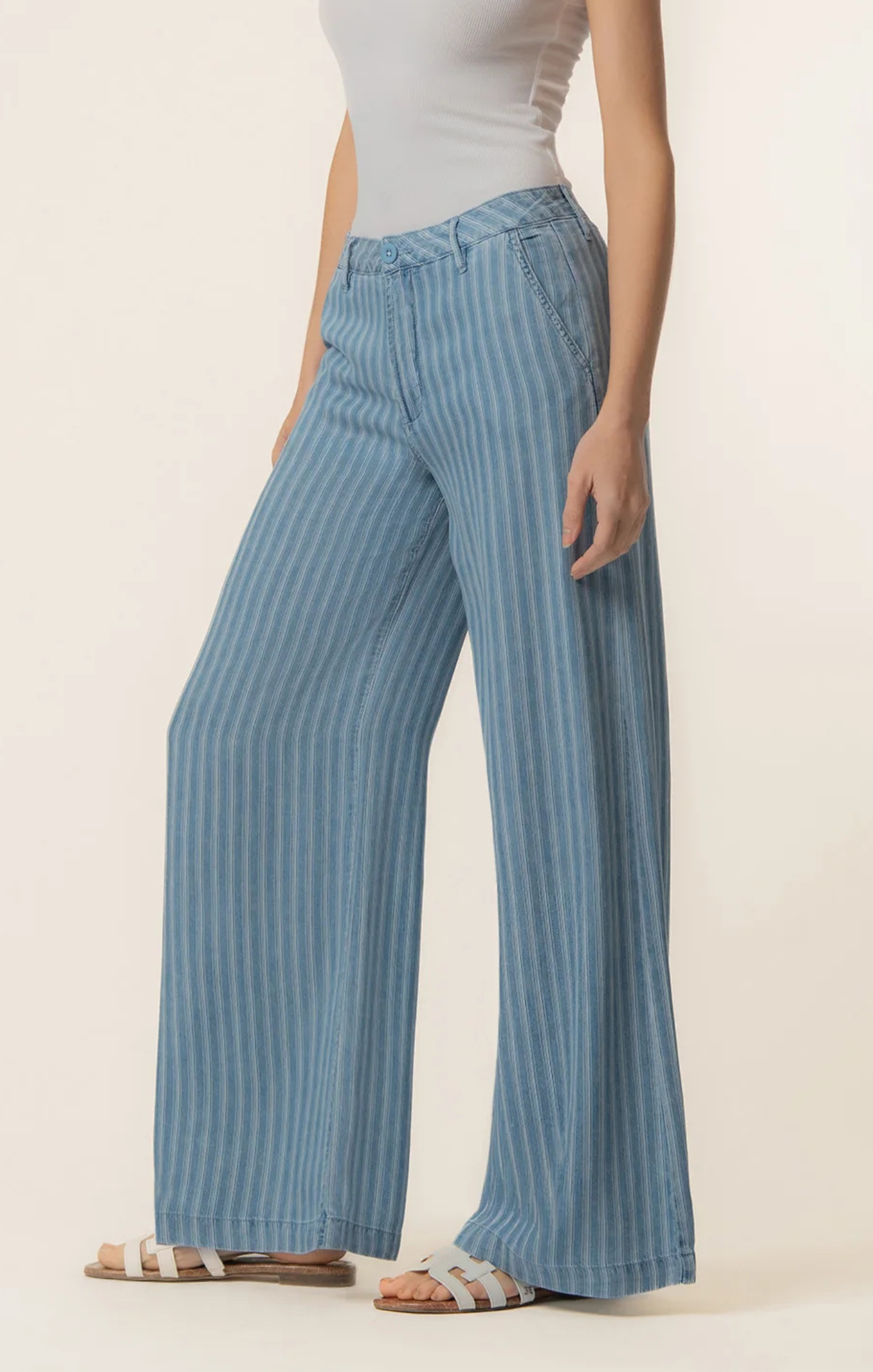 Person wearing blue striped pants on a plain background