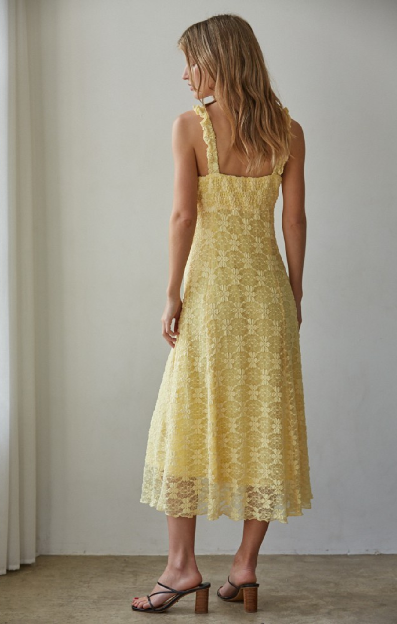 women in yellow midi dress on beige background