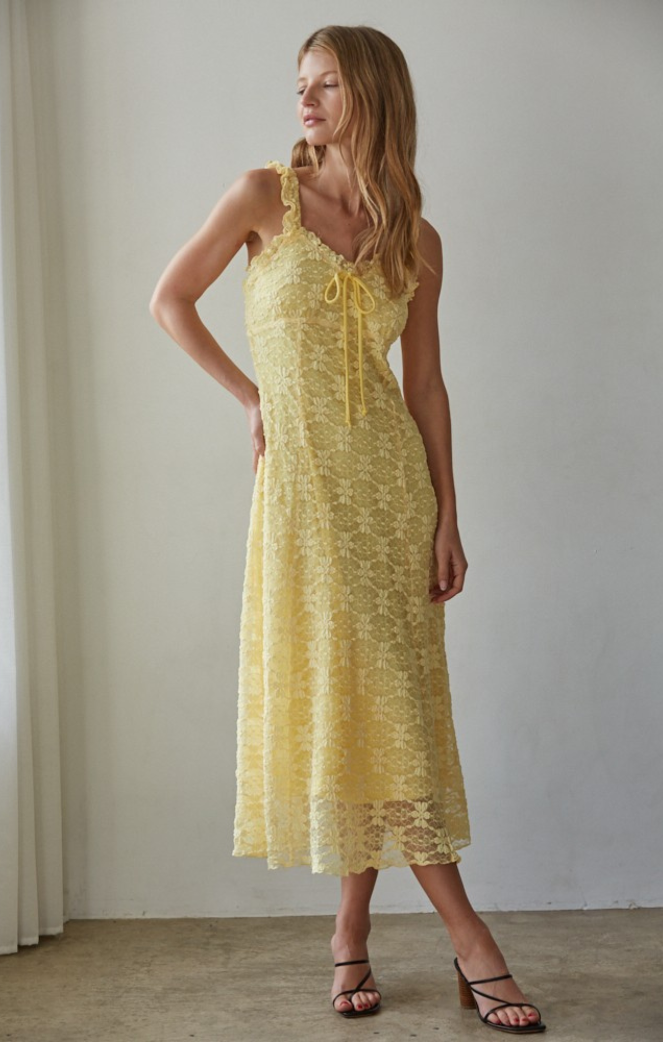 women in yellow midi dress on beige background