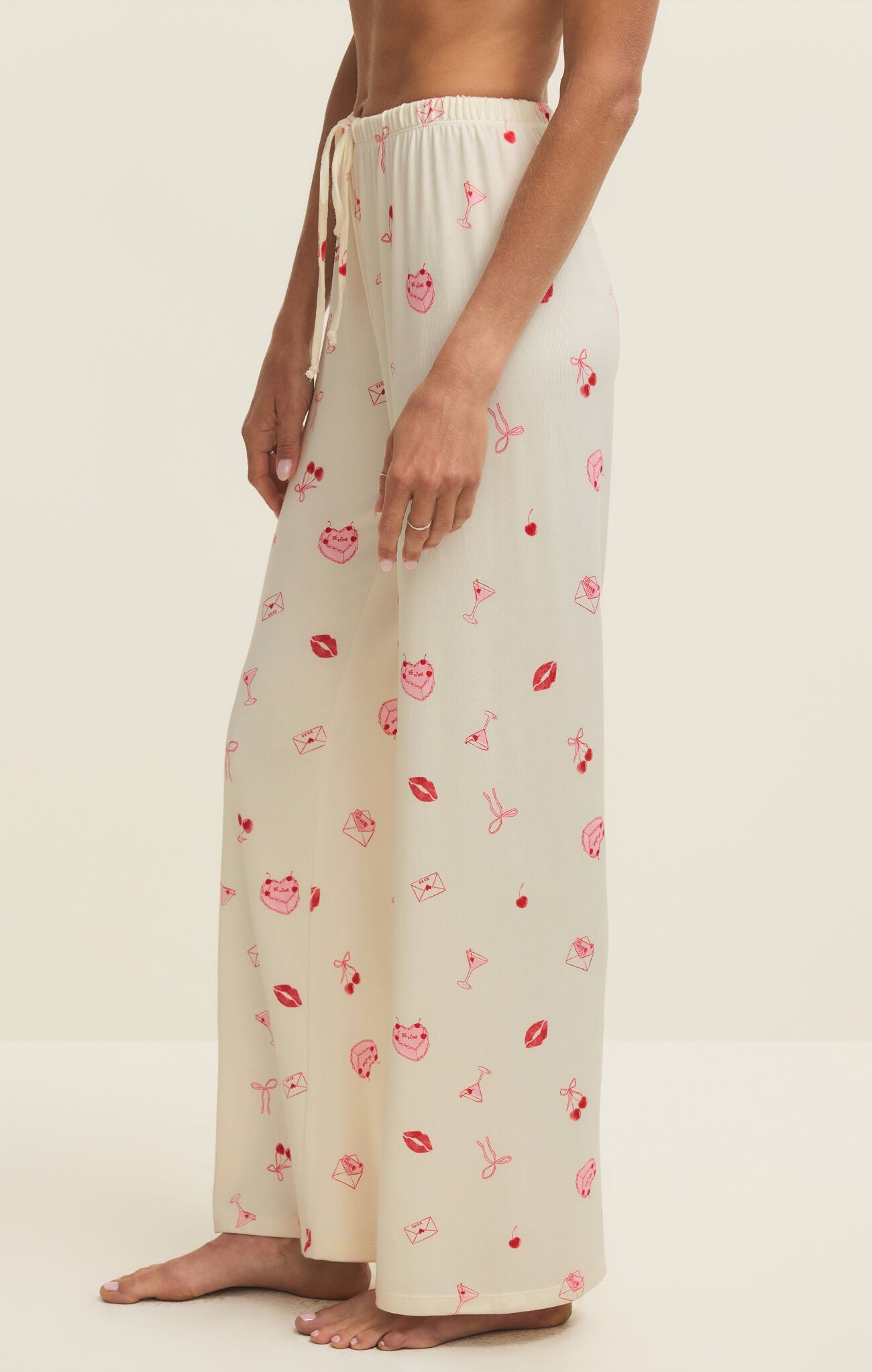 Person wearing a cream-colored lounge set with floral pattern on a white background