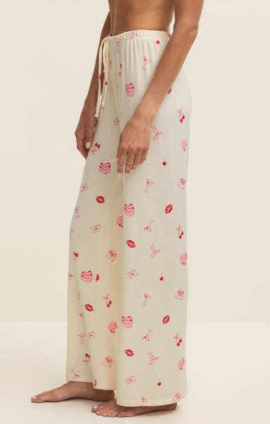 Person wearing a cream-colored lounge set with floral pattern on a white background