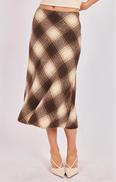 Plaid skirt worn by a person on a white background