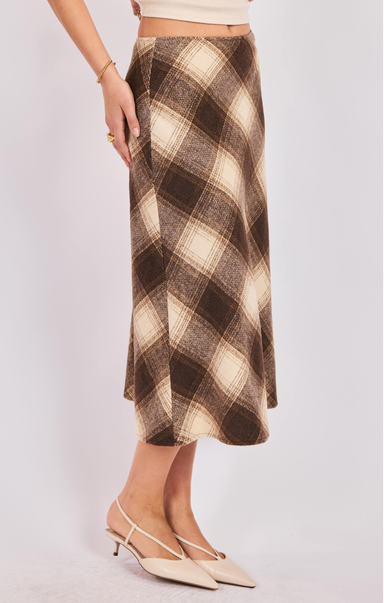 Plaid skirt worn by a person on a plain background
