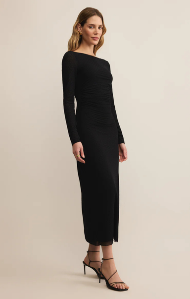 Woman wearing a black dress on a beige background