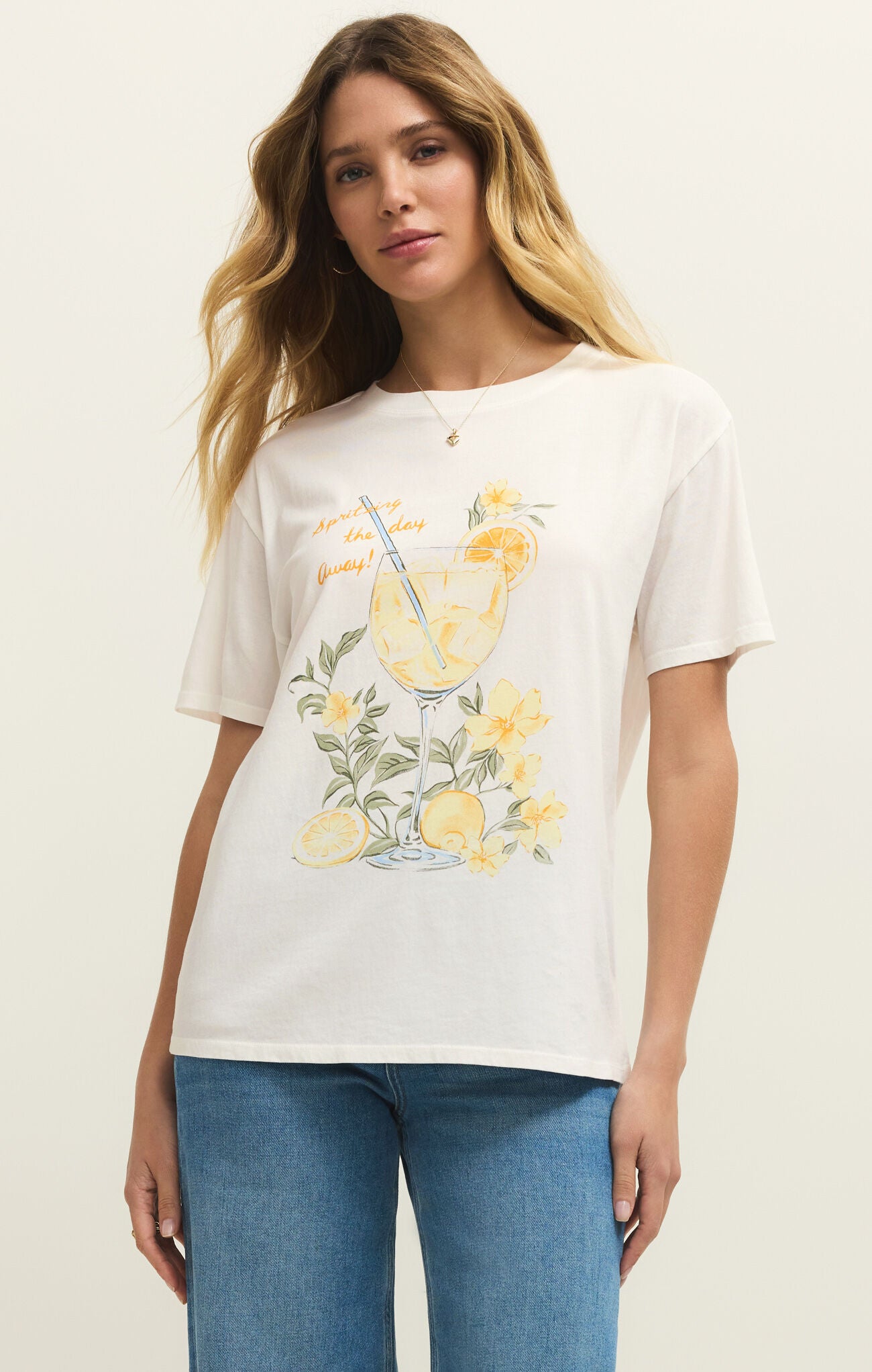 Woman wearing a white t-shirt with a lemon-themed graphic design on a plain background