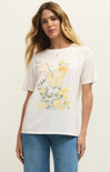 Woman wearing a white t-shirt with a lemon-themed graphic design on a plain background