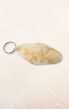 Keychain with 'Gemini' text on a beige background