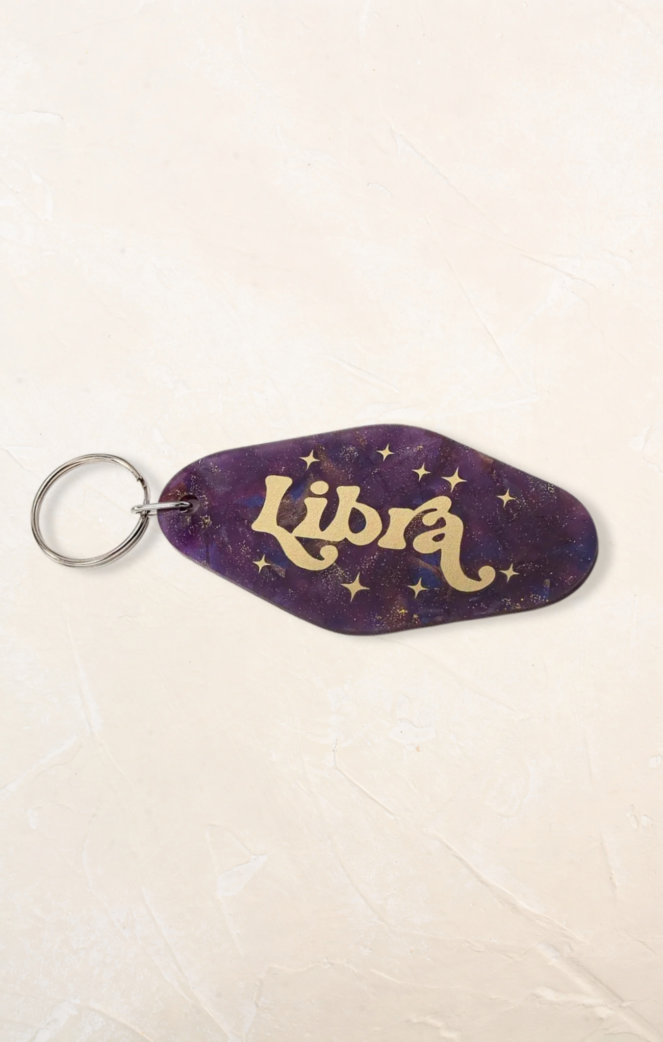 Keychain with 'Libra' text on a purple background