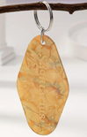 Keychain with 'Sagittarius' engraving on a branch