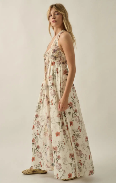 Woman wearing a floral dress on a plain background