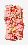 Pink fudge with raspberries on a white background