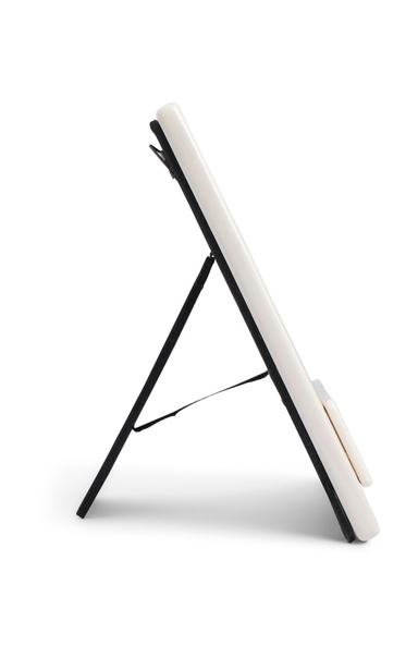 White electronic device on a black stand against a white background