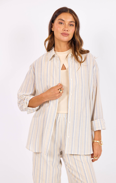 Woman wearing a striped shirt and pants on a white background