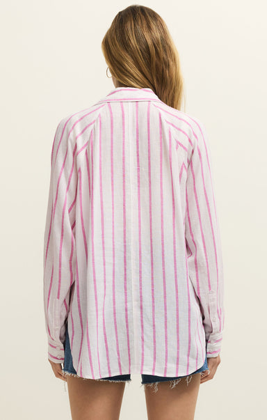 Woman wearing a pink and white striped shirt on a beige background