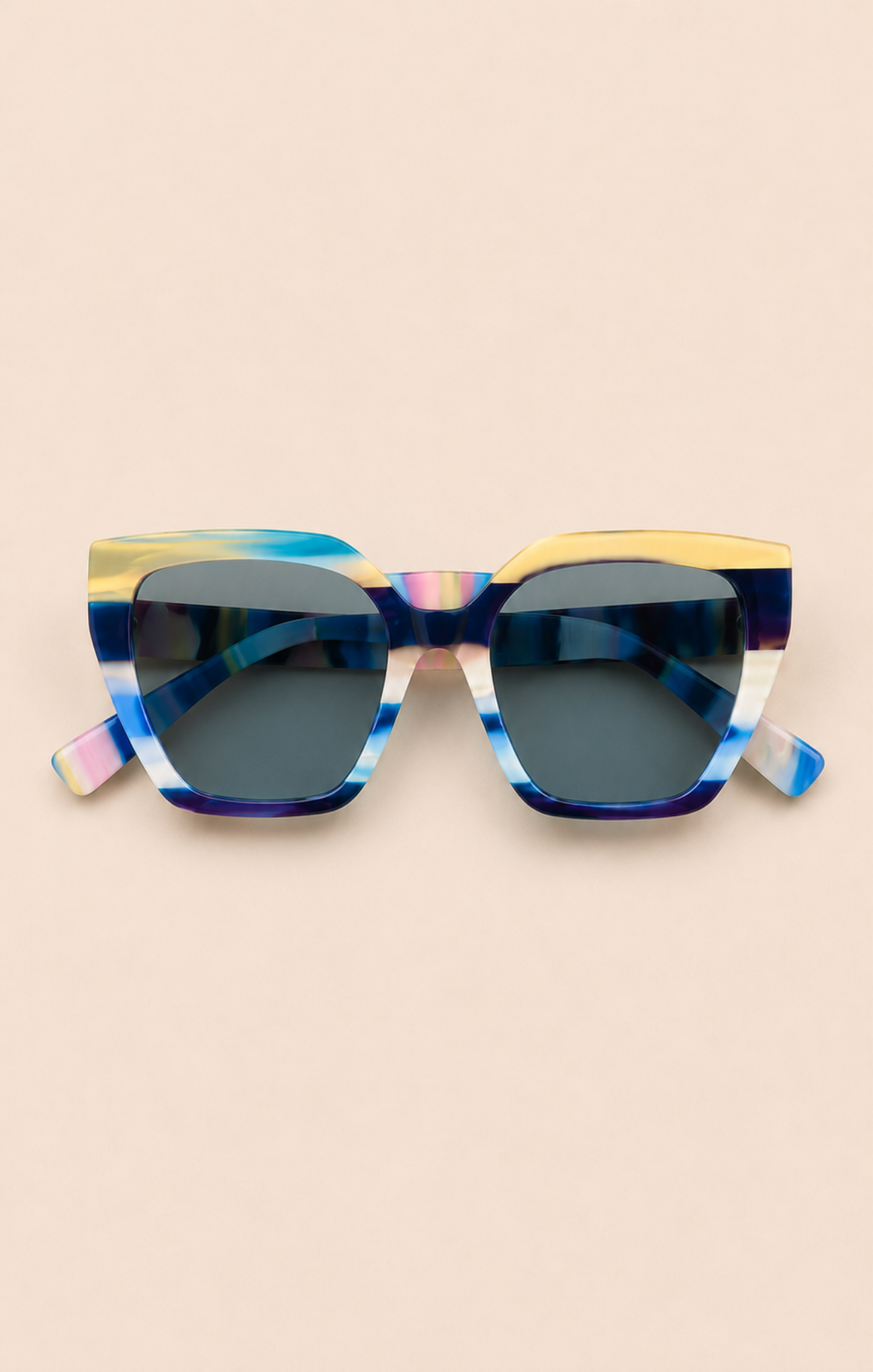 Sunglasses with a colorful frame on a beige background