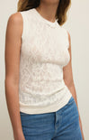 White lace sleeveless top worn by a person with a neutral background