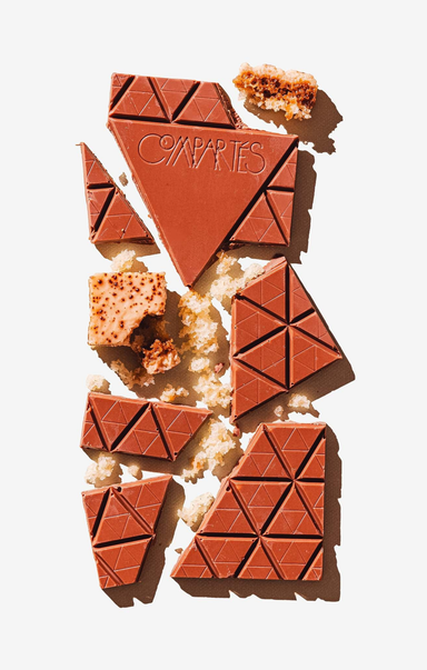 Chocolate bars with geometric design and 'Coomates' branding on a light background