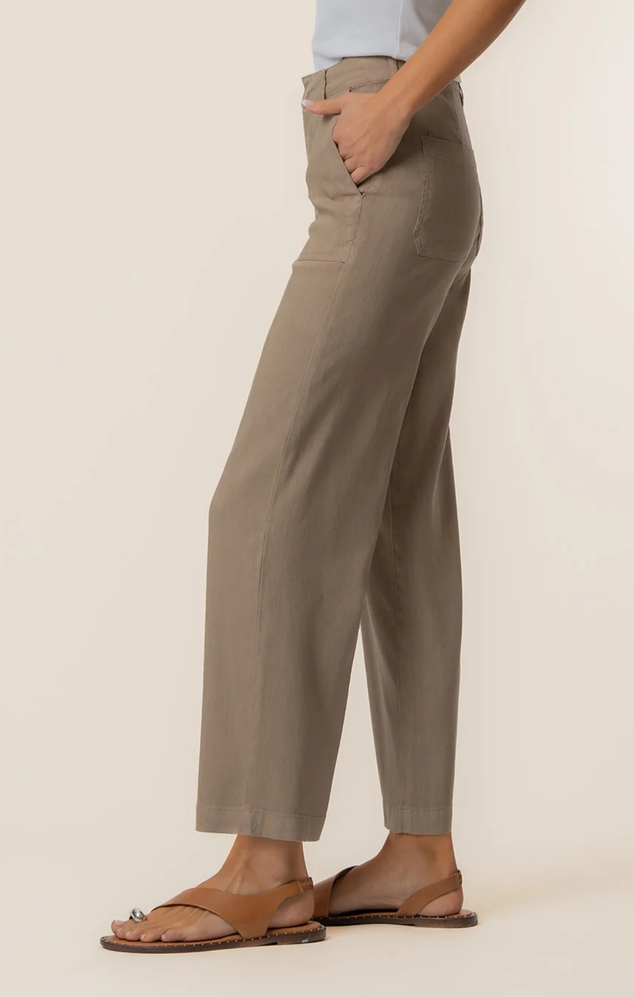 Person wearing beige pants on a plain background