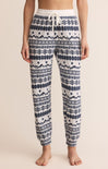Patterned pajama pants worn by a person on a beige background