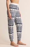 Patterned pajama pants worn by a person on a beige background