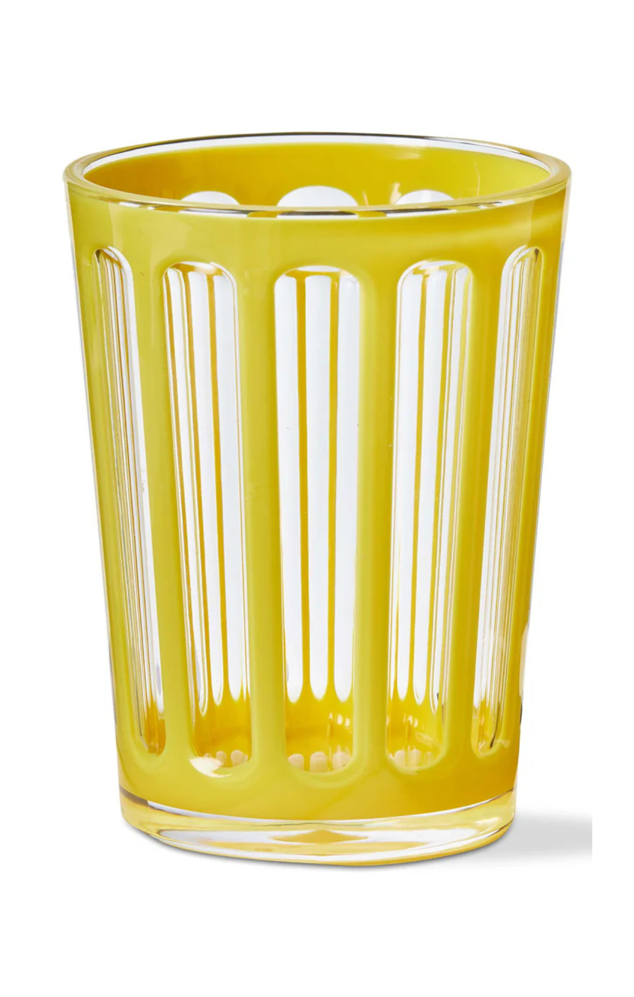 Yellow glass tumbler with vertical stripes on a white background