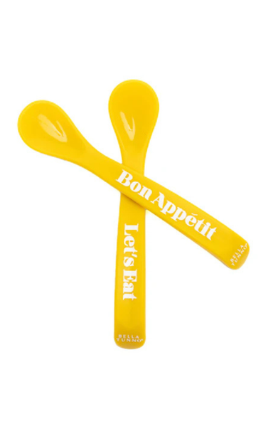 yellow spoons that say bon appetit lets eat in them on white background