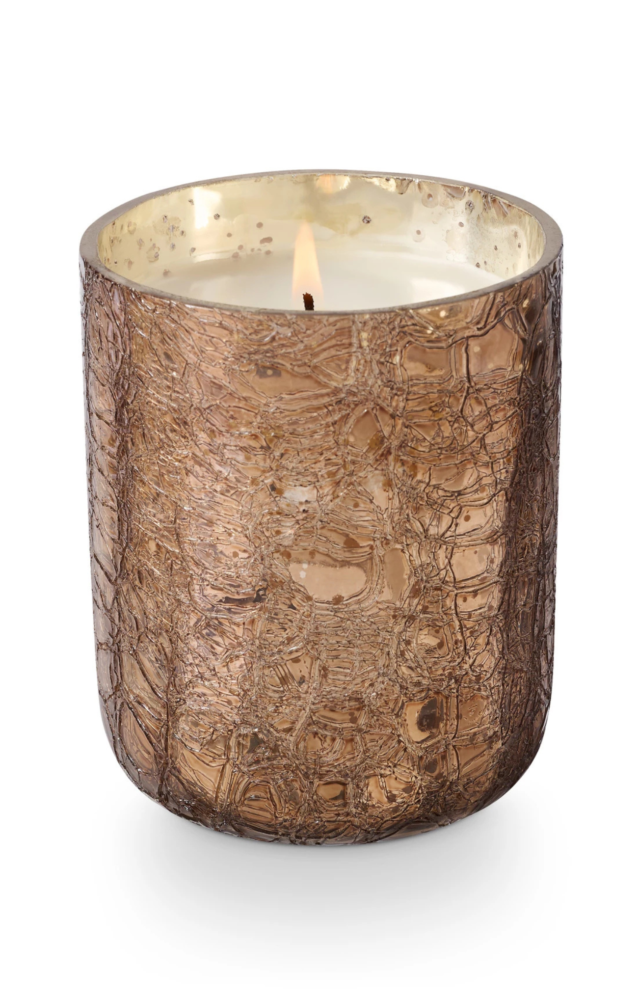 Candle in a textured bronze holder on a white background