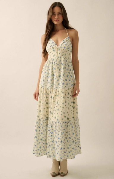 Woman wearing a floral dress against a plain background