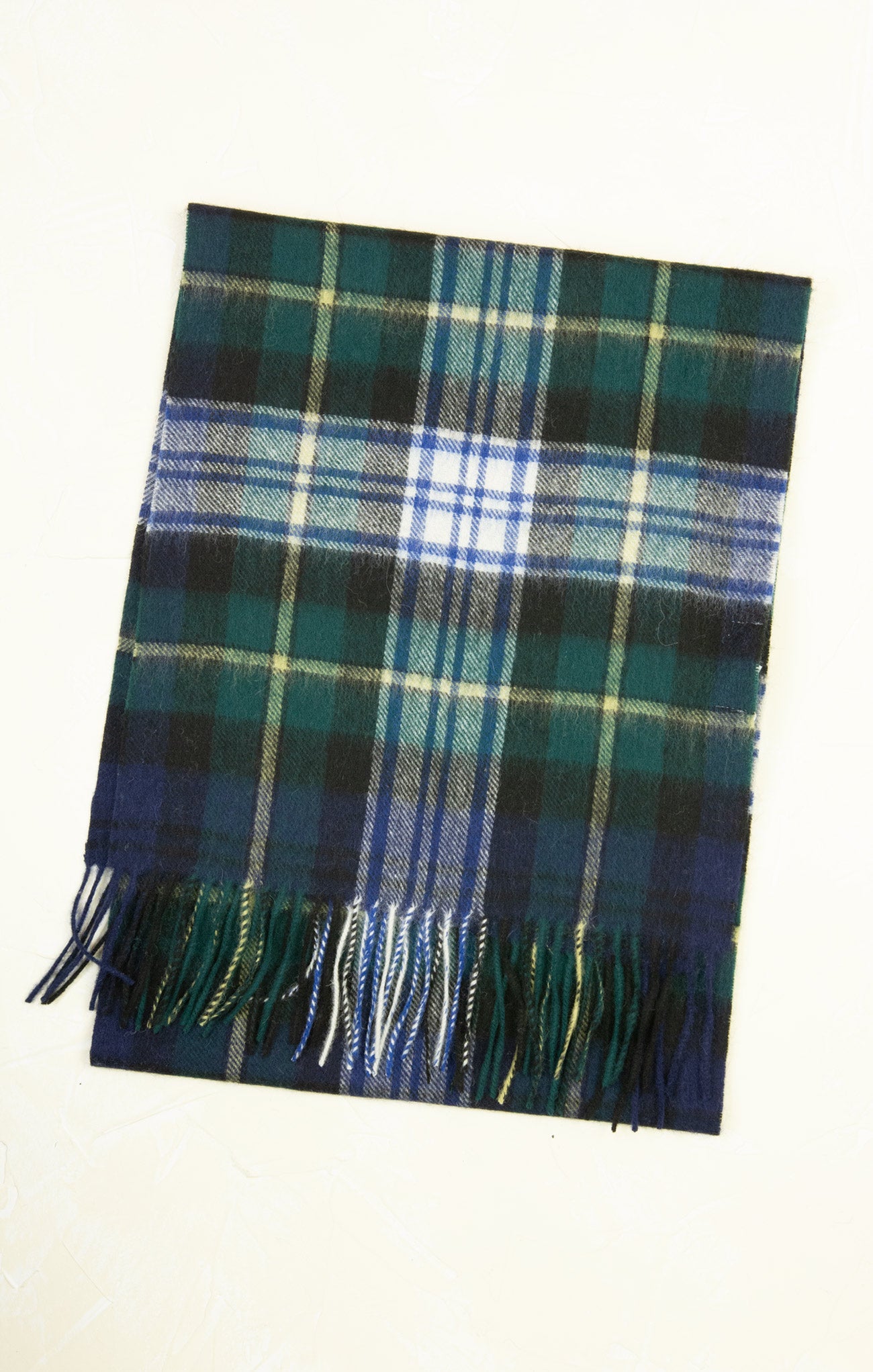 Plaid scarf with blue, green, and white colors on a white background