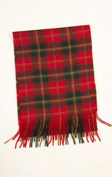 Red and green plaid scarf with fringes on a white background