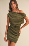 Woman wearing an olive green off-shoulder dress against a beige background