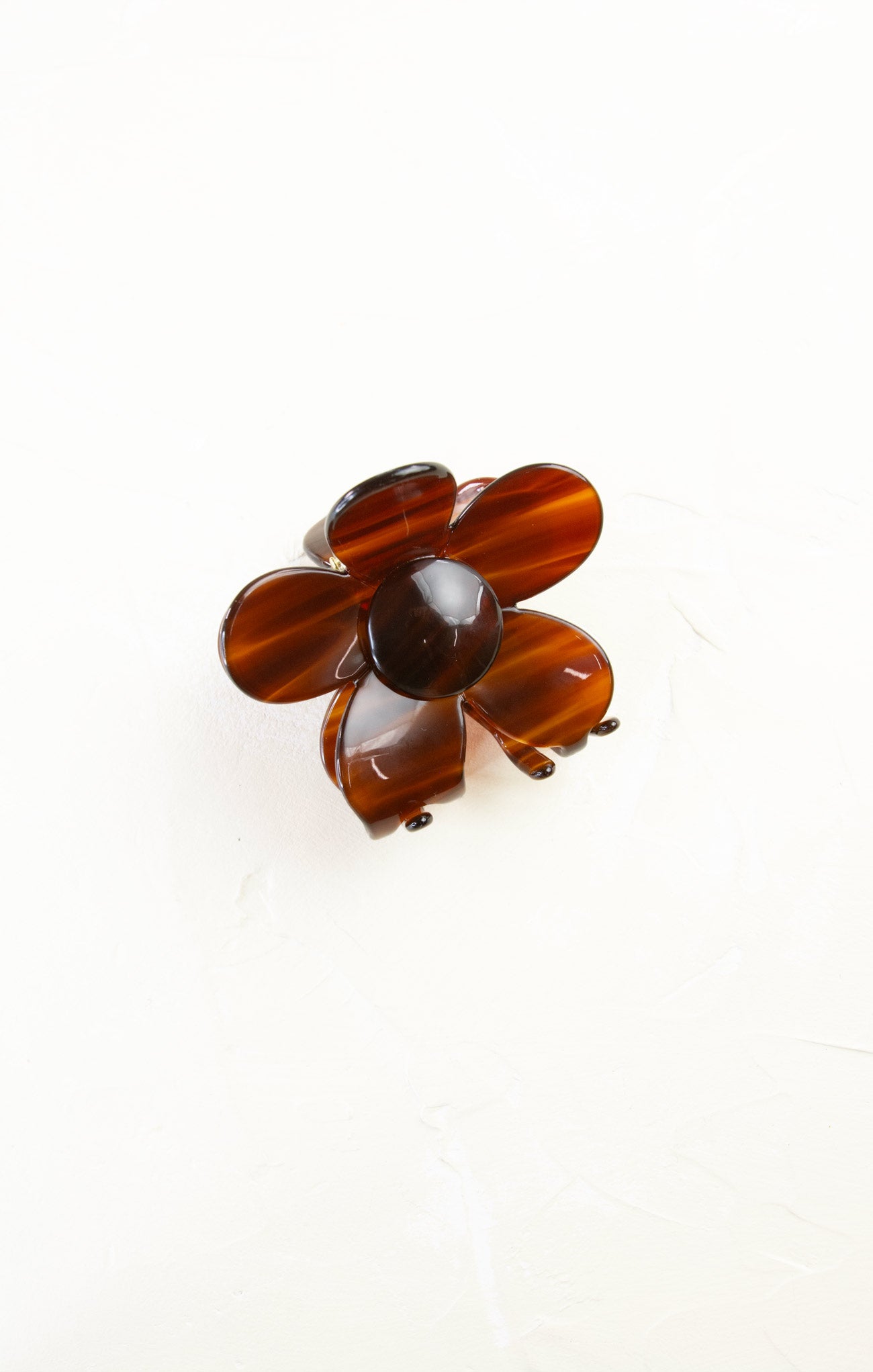 Brown flower-shaped brooch on a white background