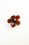 Brown flower-shaped brooch on a white background