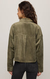 Person wearing an olive green jacket on a plain background